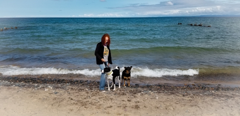 Shelli and dogs on the shore